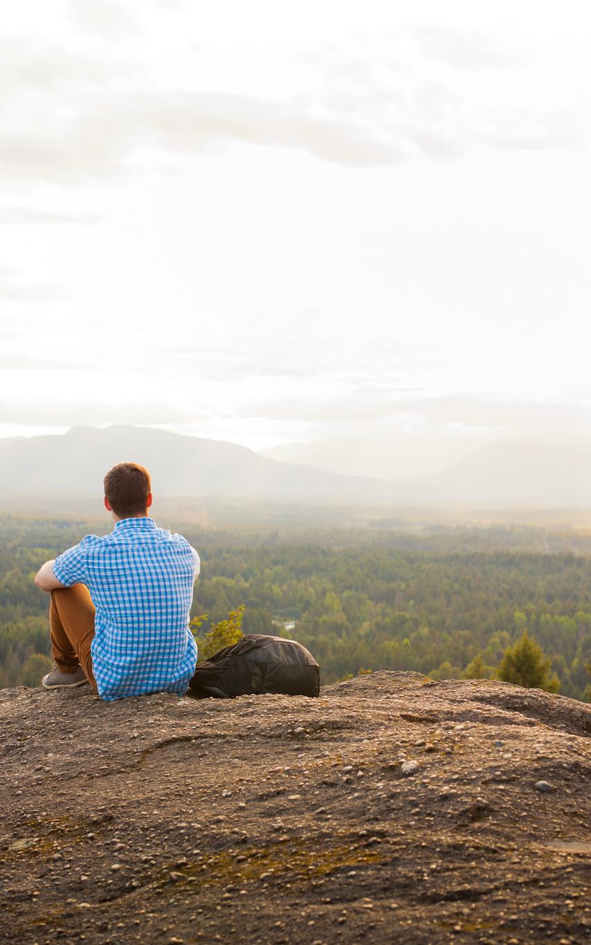 VIU Thrive student sitting on a hilltop